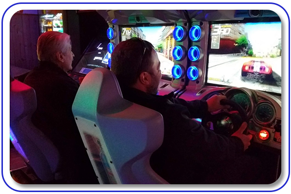 People playing a racing arcade game