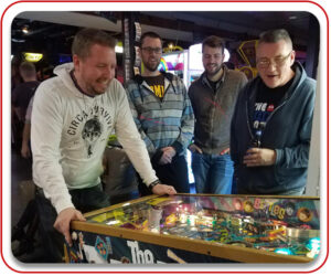 Men playing arcade games