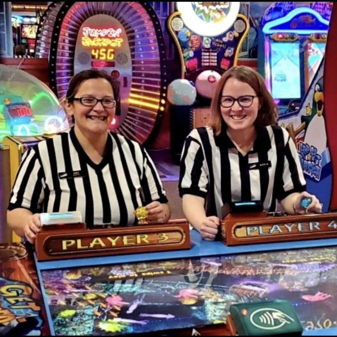 Two flippers employees wearing referee jerseys. 