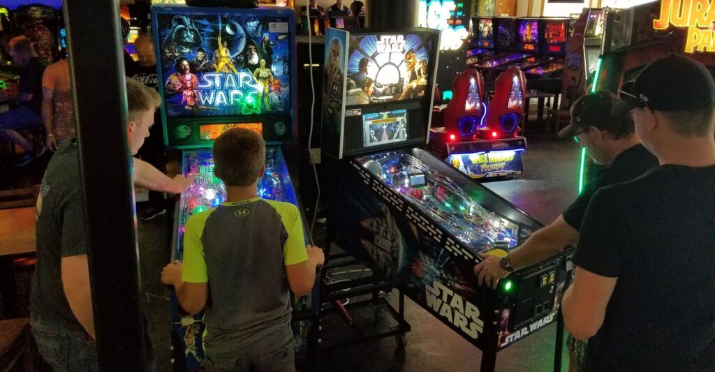 people competing in arcade games