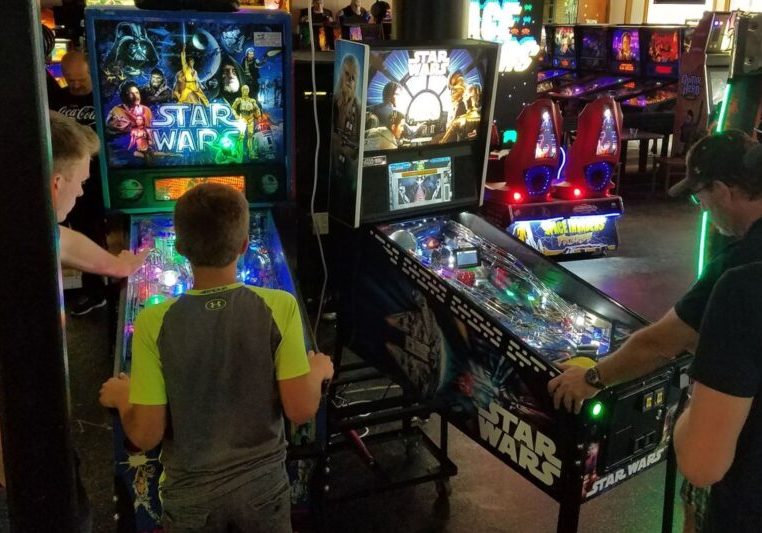 people competing in arcade games